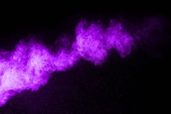 The movement of abstract dust explosion frozen purple on black background. Stop the movement of powdered purple on black background. Explosive powder purple on black background.