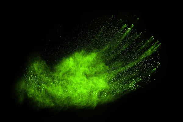 The movement of abstract dust explosion frozen green on black background. Stop the movement of powdered green on black background. Explosive powder green on black background.