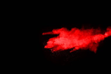 Siyah arka planda soyut kırmızı toz patlaması. Siyah arka planda soyut kırmızı toz sıçramış. Patlayan kırmızı barutun hareketsiz hareketi.