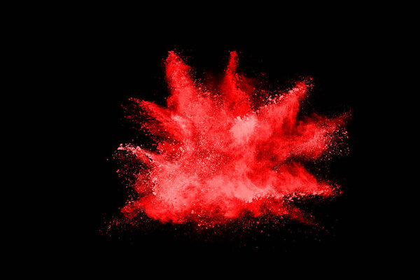 abstract red powder explosion on black background.abstract red powder splatted on black background. Freeze motion of red powder exploding.