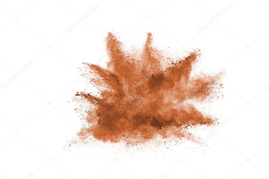 Brown color powder explosion on white background. Colored cloud. Colorful dust explode. Paint Holi.