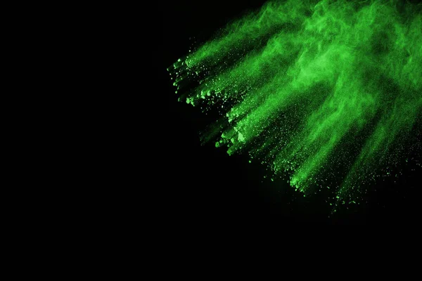 The movement of abstract dust explosion frozen green on black background. Stop the movement of powdered green on black background. Explosive powder green on black background.