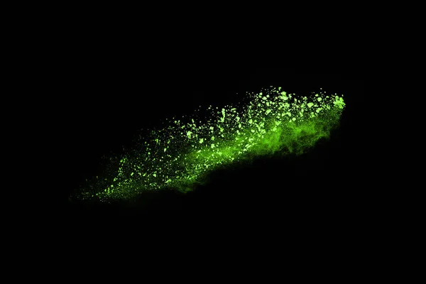 The movement of abstract dust explosion frozen green on black background. Stop the movement of powdered green on black background. Explosive powder green on black background.