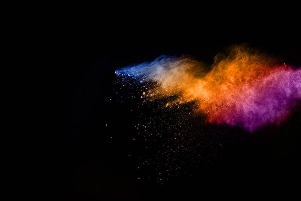 abstract colored dust explosion on a black background.abstract powder splatted background,Freeze motion of color powder exploding/throwing color powder, multicolored glitter texture.