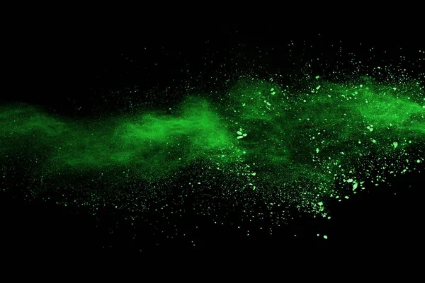 The movement of abstract dust explosion frozen green on black background. Stop the movement of powdered green on black background. Explosive powder green on black background.