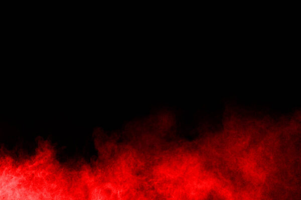 Abstract red powder explosion on black background.abstract red powder splatted on black background. Freeze motion of red powder exploding.