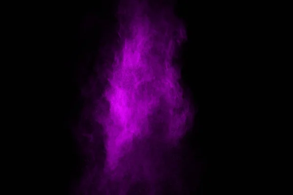 The movement of abstract dust explosion frozen purple on black background. Stop the movement of powdered purple on black background. Explosive powder purple on black background.