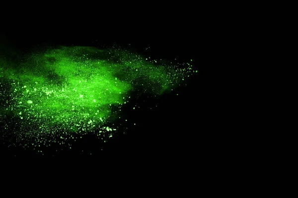 The movement of abstract dust explosion frozen green on black background. Stop the movement of powdered green on black background. Explosive powder green on black background.