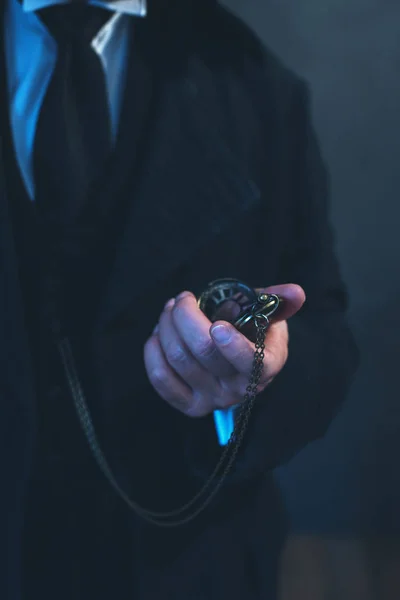 Edwardian man in long black coat holding pocket watch. — Stock Photo, Image