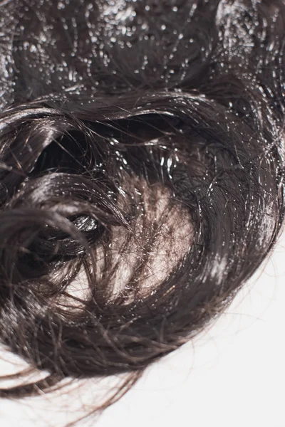 Detalhe do cabelo encaracolado marrom deitado na água na pia . — Fotografia de Stock