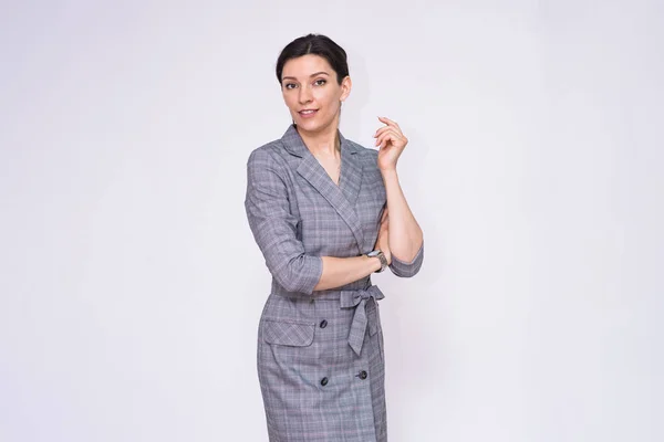 Let\'s talk about this. Portrait of a beautiful business woman manager on a white background. She is right in front of the camera smiling and looks attentive