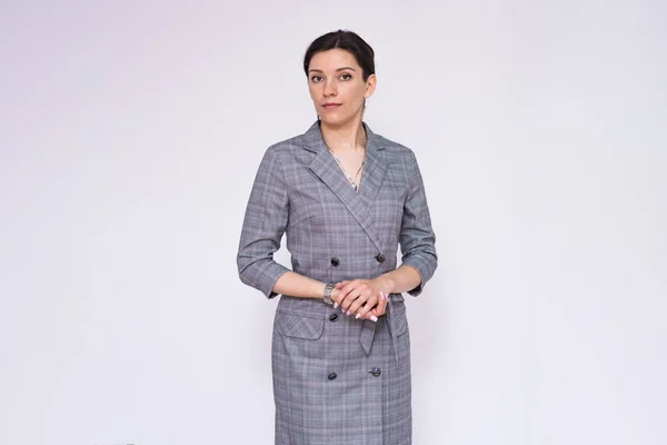 Let\'s talk about this. Portrait of a beautiful business woman manager on a white background. She is right in front of the camera smiling and looks attentive