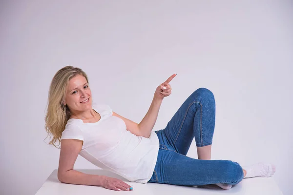 Portrait Beautiful Blonde Girl White Background Lying Table She Lies — Stock Photo, Image