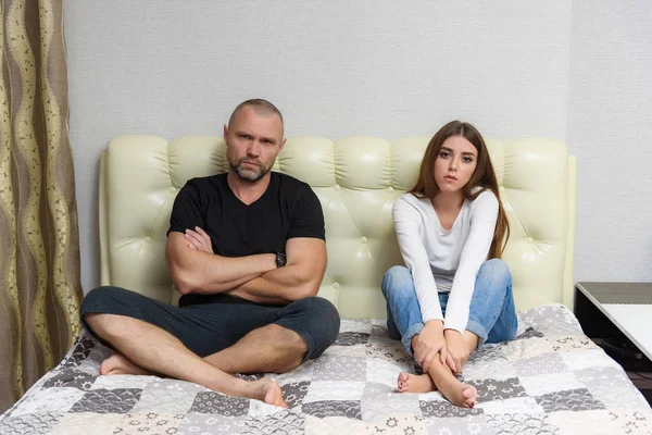 Family conflict, family problems, family relationships of a disgruntled father and adult daughter in a room on the sofa. — Stock Photo, Image