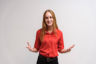 Stüdyo portre fotoğraf gülümseyen güzel bir kızın uzun saçlı beyaz bir arka plan duygu ile konuşurken. O çeşitli pozlar kamera önünde duruyor ve mutlu görünüyor.