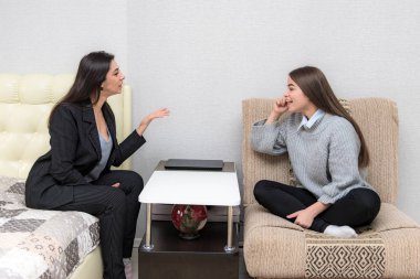 Aile sorunları, Aile ilişkileri anne ve genç kızı koltukta bir odada. Kanepede oturup memnun bakmak.