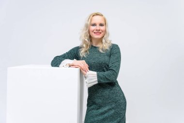 duran kadın kavramı beyaz bir arka plan beyaz küpleri ve kameraya baktığımızda, onlar are ortasında belgili tanımlık çerçevelemek ve Yeşil elbiseli bir kız gülümseyerek ve beyaz saçlı o makyaj vardır.