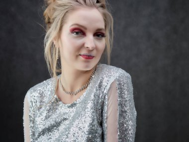 Gri bir fon üzerinde güzellik portresi bir gülümseyen sarışın kadın. Temiz cilt, doğal makyaj ve Güzellik Salonu gri bir arka plan üzerinde beyaz dişler ile gülümseyen kız