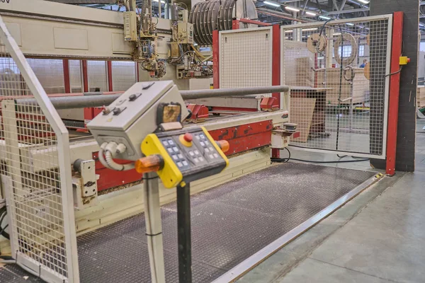 Laying chipboard for processing and production of furniture in a woodworking enterprise. Production line in a furniture factory. Milling and sawing machine for wood processing.