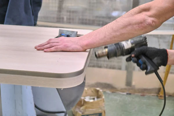 Laying chipboard for processing and production of furniture in a woodworking enterprise. Production line in a furniture factory. Milling and sawing machine for wood processing.