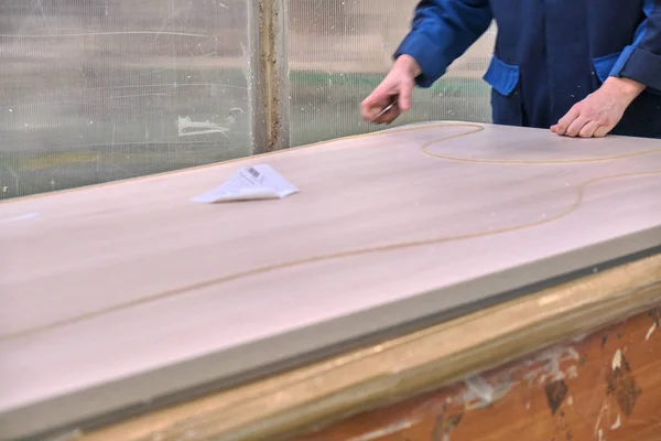 Laying chipboard for processing and production of furniture in a woodworking enterprise. Production line in a furniture factory. Milling and sawing machine for wood processing.