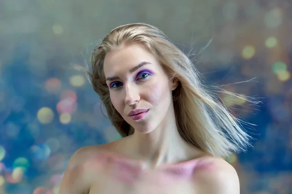 Concepto de retrato de cerca de una hermosa chica rubia sobre un fondo multicolor. El cabello se desarrolla en diferentes direcciones . —  Fotos de Stock