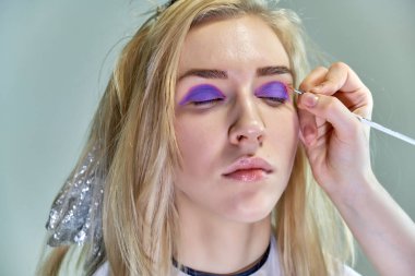 Office ile Şevval Özçelik Güzellik Güzellik Uzmanı kavramı eseri. Saç yapar, gri bir arka plan üzerinde makyaj geçerlidir.