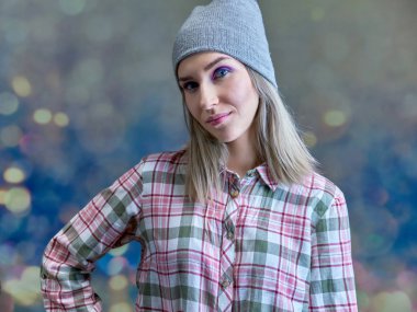 Close-up portrait concept of a beautiful blonde girl on a multi-colored background. Hair develops in different directions. clipart