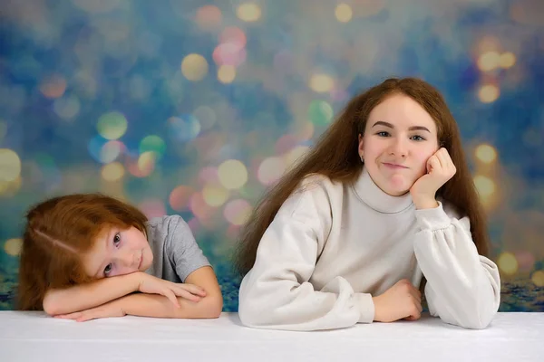 Concepto de retrato de dos lindas hermanas guapas con el pelo rojo sobre un fondo de color sonriendo y hablando . —  Fotos de Stock