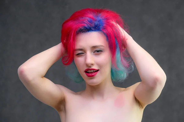 High fashion model woman with multi-colored hair posing in the studio, portrait of a beautiful sexy girl with a fashionable makeup. — Stock Photo, Image