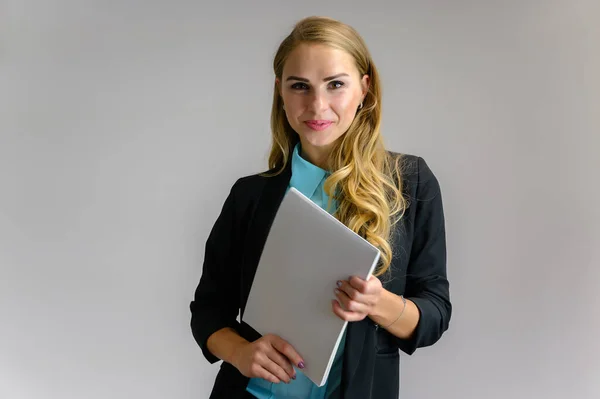 Portrait of a pretty blonde girl financial secretary with long curly hair in a business suit standing in the studio on a white background with emotions in different poses with a folder in his hands. — Stock Photo, Image