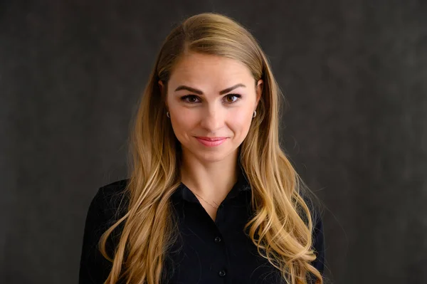 Close-up portrait of a pretty blonde girl with long curly hair standing in the studio on a gray background with emotions in different poses. Beauty, Model, Cosmetics — Stock Photo, Image