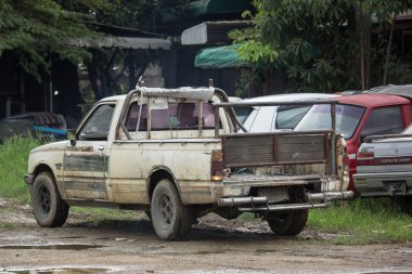 Chiangmai, Thailand - August  6 2018:   Private Isuzu KB Old Pickup car. Photo at road no 121 about 8 km from downtown Chiangmai thailand. clipart