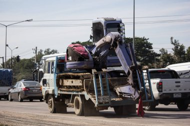 Chiangmai, Thailand - January 4 2019:  Private Komatsu backhoe on truck. On road no.1001, 8 km from Chiangmai city.