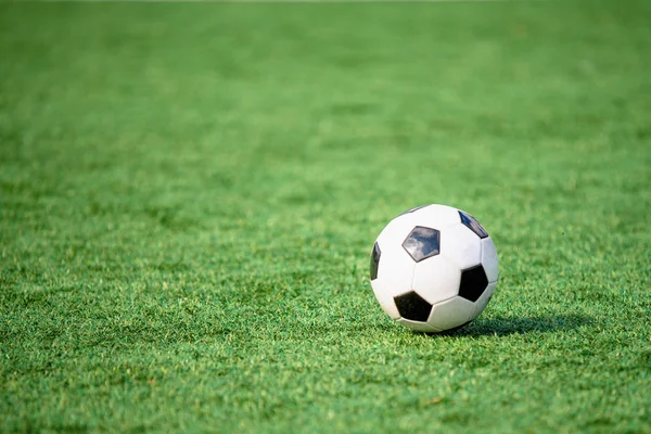 Soccer ball or football ball on green field — Stock Photo, Image