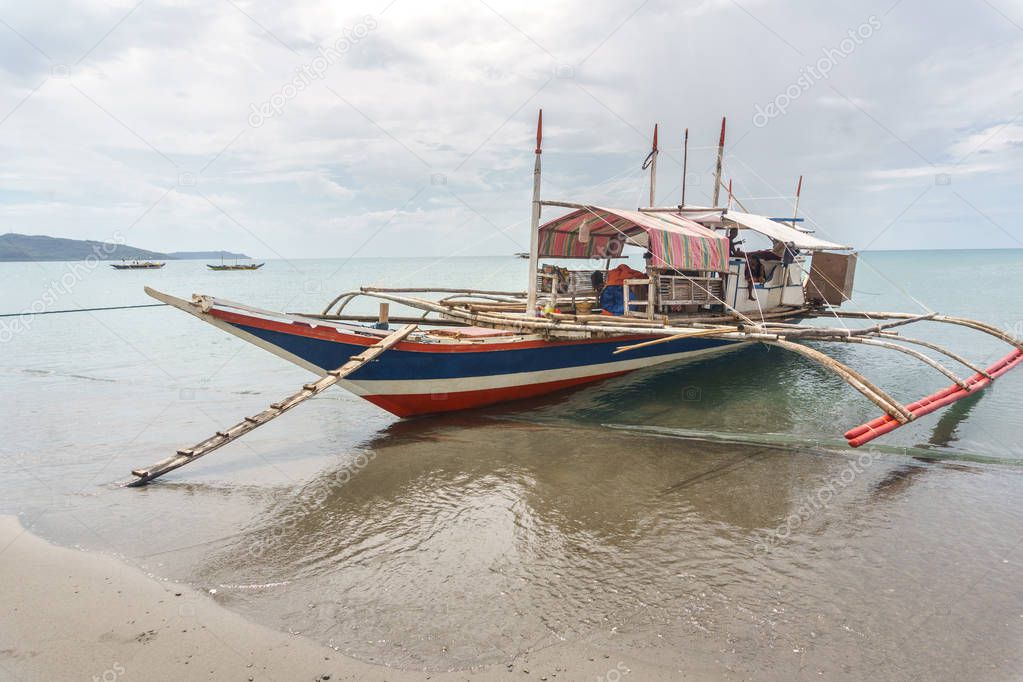 Classic Philippine fishing boat on the background of the sea landscape.
