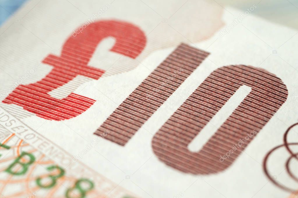 Fragment of ten pounds bills closeup. Shallow depth of field