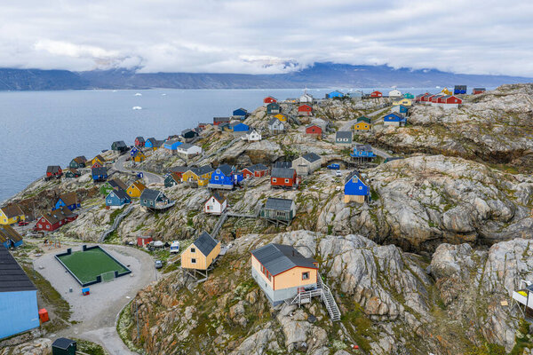 Birds-eye view. Uummannaq island dotted with colorful Inuit houses in sunny day in summer. High quality photo