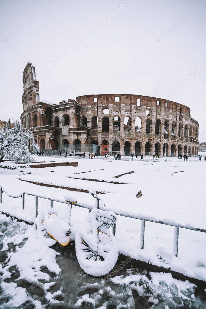 A lovely day of snow in Rome, Italy, 26th February 2018: a view of snowy bikes behind the Colosseum