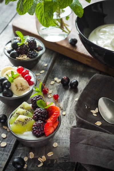Proteic greek yogurts with fruits: banana, berries, kiwi