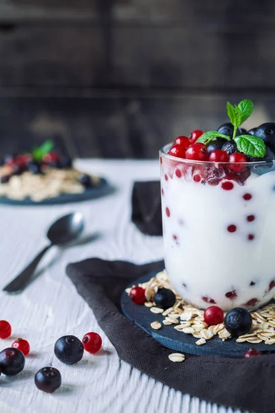 Healthy homemade greek yogurt with ribes, blueberries, oatmeal a