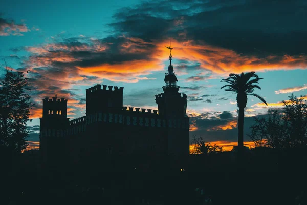 Silhouette of ciutadella garden over colorful sunset sky in Barcelona, Spain