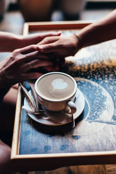 Het stel in het café houdt de hand zachtjes vast. Een kop koffie.. — Stockfoto