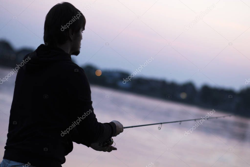 Fisherman. Young man fishing on the river.