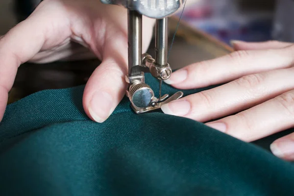 Young woman on her sewing process, women's hands behind her work — Stock Photo, Image