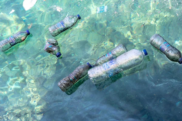Greece, June, 5, 2020: A group of floating plastic bottles on water surface. Enviromental pollution by plastic