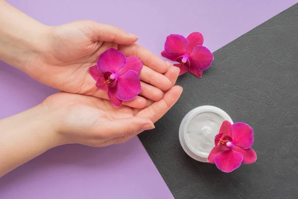 Cosmetic Background Hands Holding Magenta Orchid Soft White Cream Nearby — Stock Photo, Image