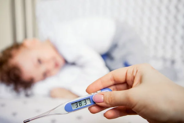 flu epidemic. Close-up of a high-temperature thermometer. sick kid