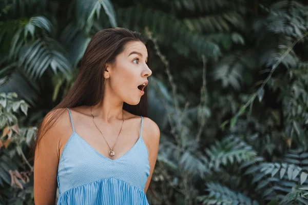 Happy and surprised young woman traveler at beach vacation