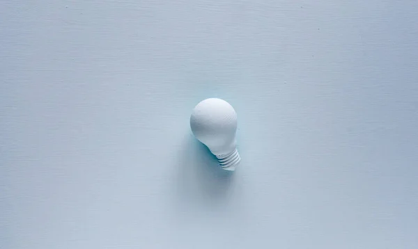 Light bulb painted with paint in pastel background. Creative idea concept.